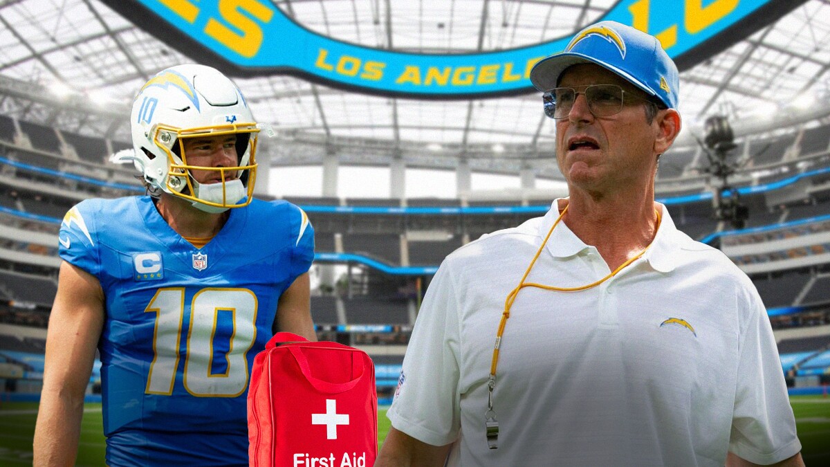 Justin Herbert with a first aid kit near him. Jim Harbaugh.