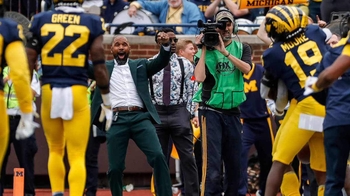 Charles Woodson, center, celebrates an interception made by Michigan defensive back R.J. Moten (6) against Maryland during the second half at the Michigan Stadium in Ann Arbor on Saturday, Sept. 24, 2022.