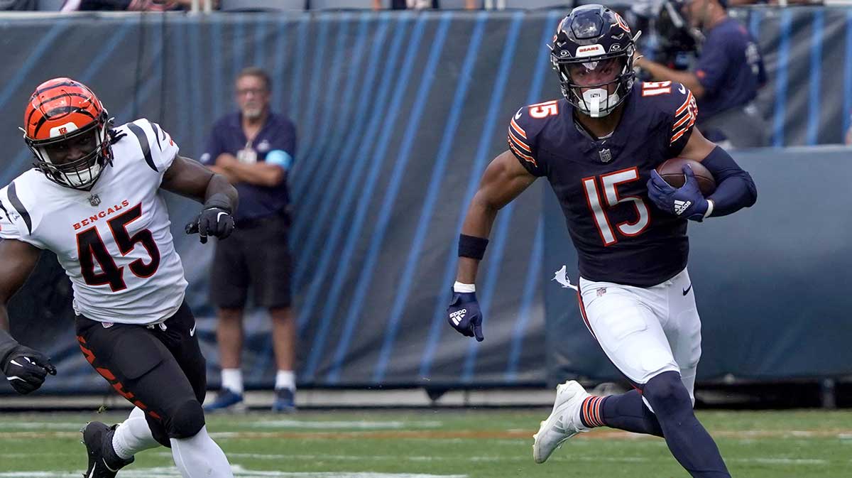 Chicago Bears wide receiver Rome Odunze (15) catches a pass as Cincinnati Bengals linebacker Maema Njongmeta (45) pursues him during the first half at Soldier Field. 