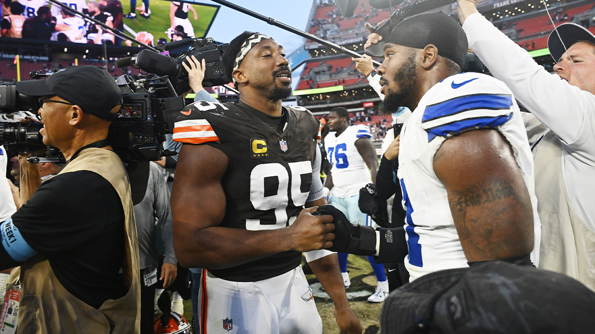 Cleveland Browns defensive end Myles Garrett (95) talks to Dallas Cowboys linebacker Micah Parsons (11) after the game at Huntington Bank Field.