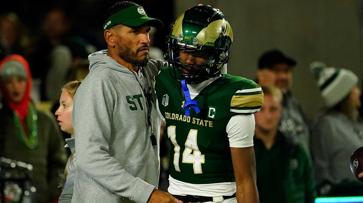 Colorado State Rams head coach Jay Norvell (left) hugs Colorado State Rams wide receiver Tory Horton (14) during pre-game warmups at Sonny Lubick Field at Canvas Stadium.