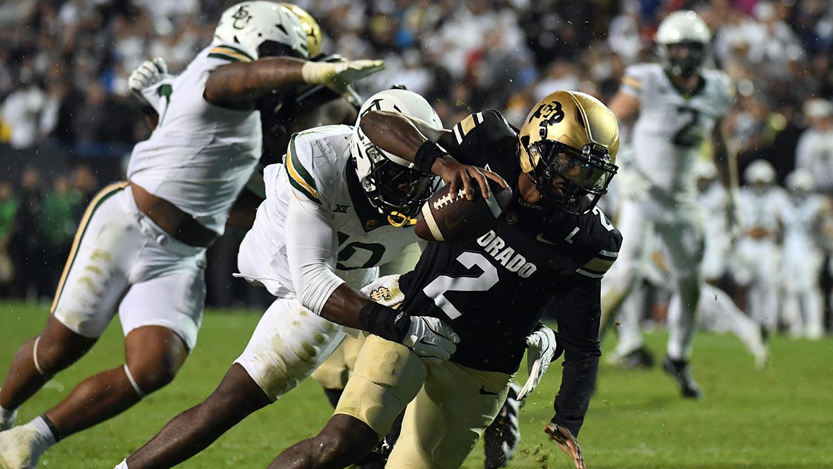 Colorado Buffaloes quarterback Shedeur Sanders (2) is sacked by Baylor Bears linebacker Steve Linton (10) during the second half at Folsom Field.