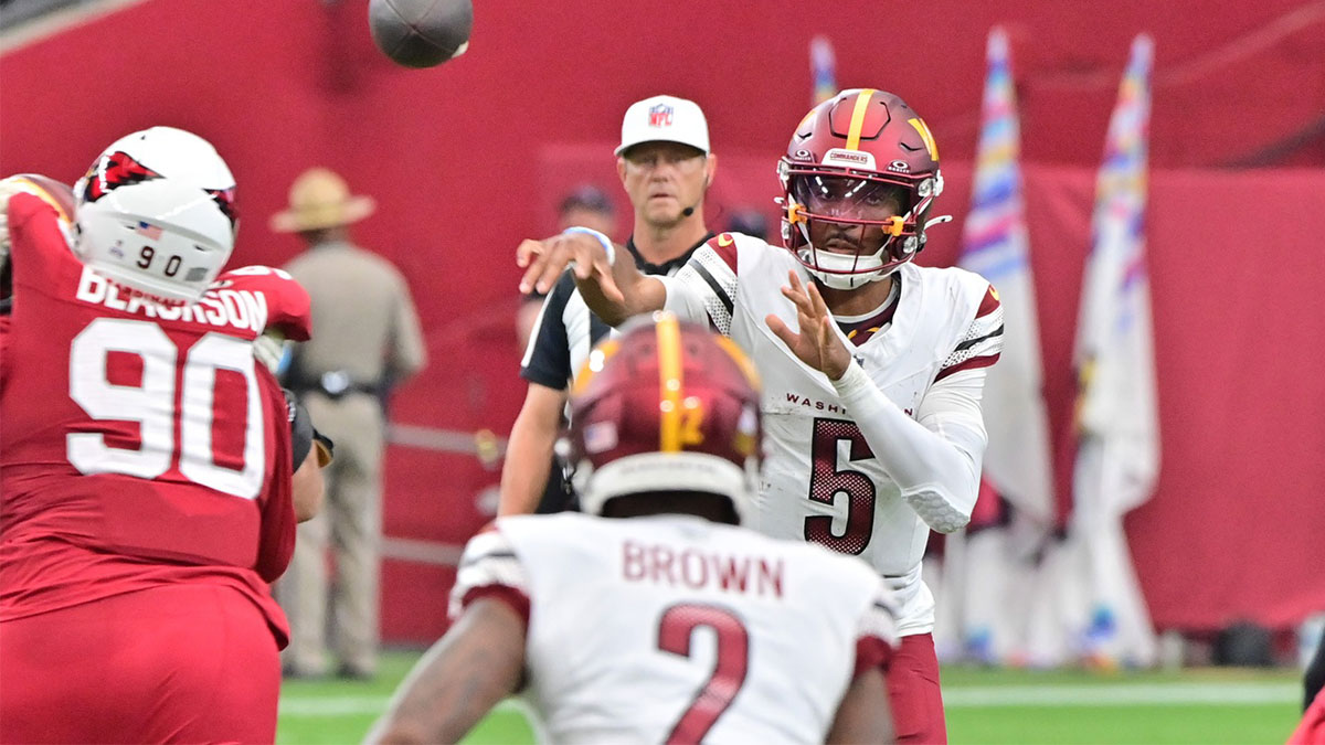 Washington Commanders quarterback Jayden Daniels (5) throws to wide receiver Dyami Brown (2) in the second half against the Arizona Cardinals at State Farm Stadium.