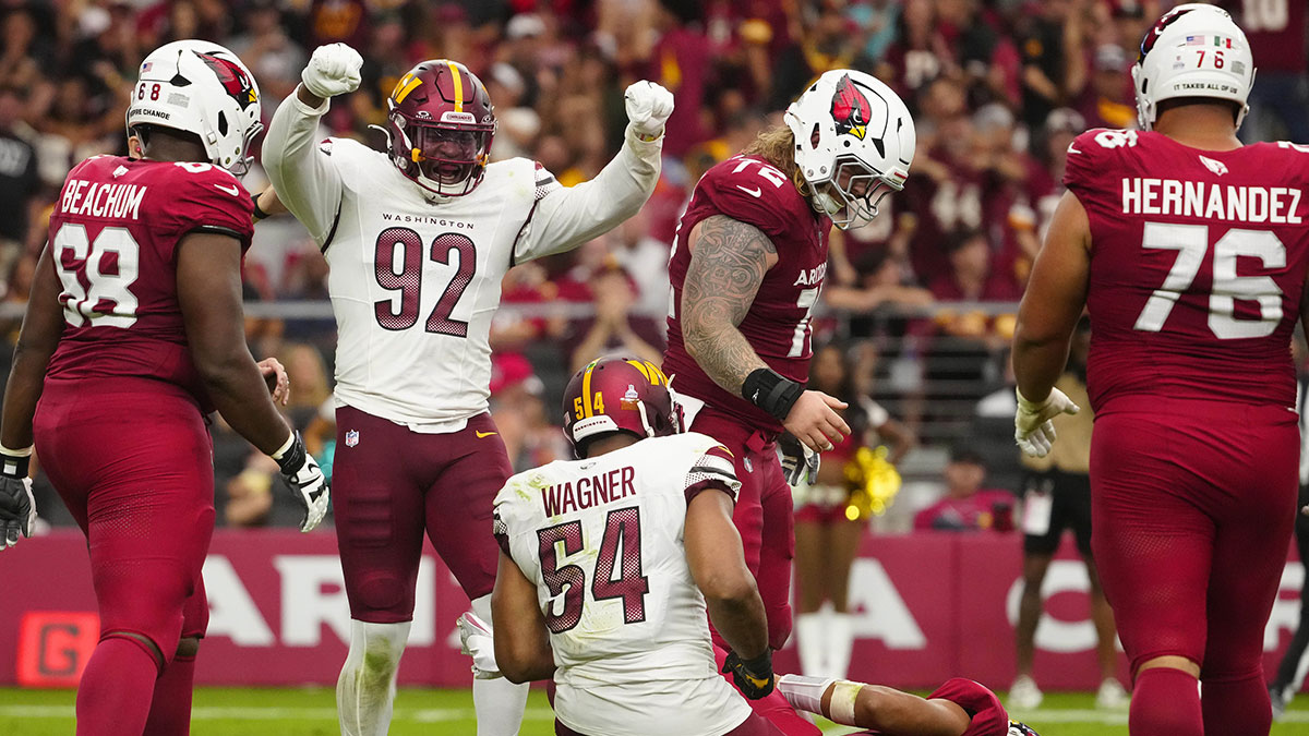 Commanders Dorance Armstrong (92) celebrates a Bobby Wagner (54) sack on Cardinals Kyler Murray (1) during a game at State Farm Stadium.