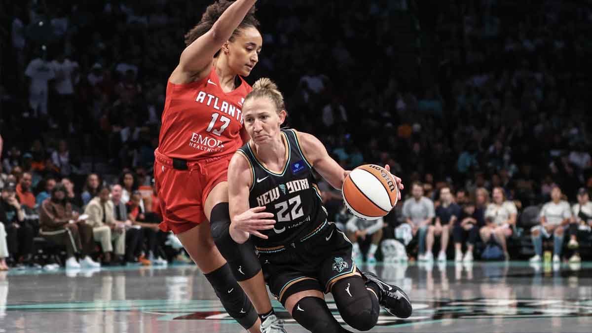 New York Liberty guard Courtney Vandersloot (22) drives past Atlanta Dream guard Haley Jones (13) during game one of the first round of the 2024 WNBA Playoffs at Barclays Center.