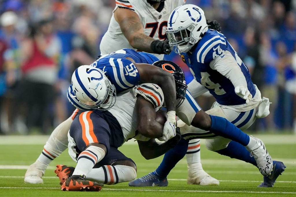Indianapolis Colts linebacker E.J. Speed (45) tackles Chicago Bears running back D'Andre Swift (4) on during a game against the Chicago Bears at Lucas Oil Stadium.