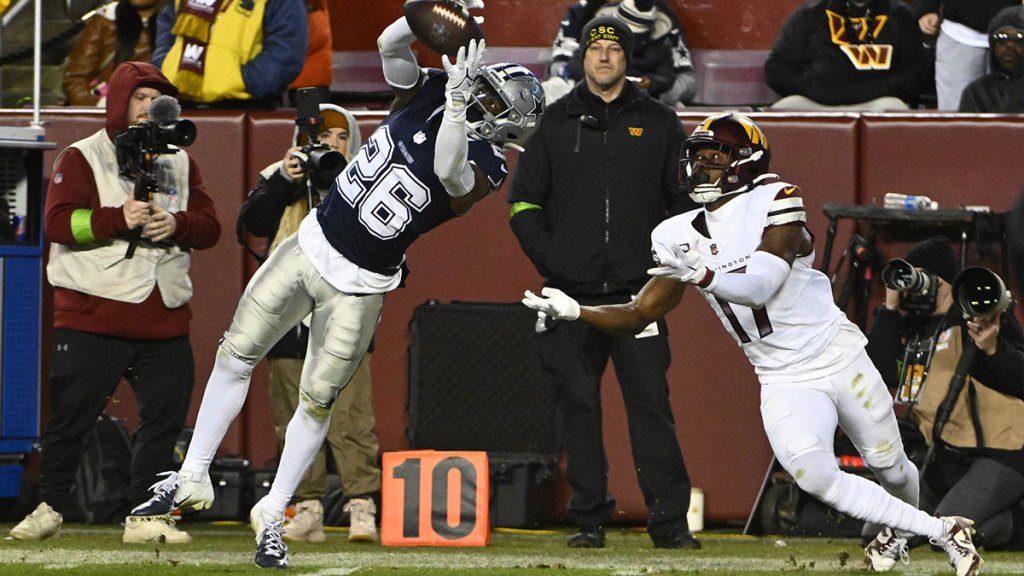 Dallas Cowboys cornerback DaRon Bland (26) intercepts a pass intended for Washington Commanders wide receiver Terry McLaurin (17) during the second half at FedExField.