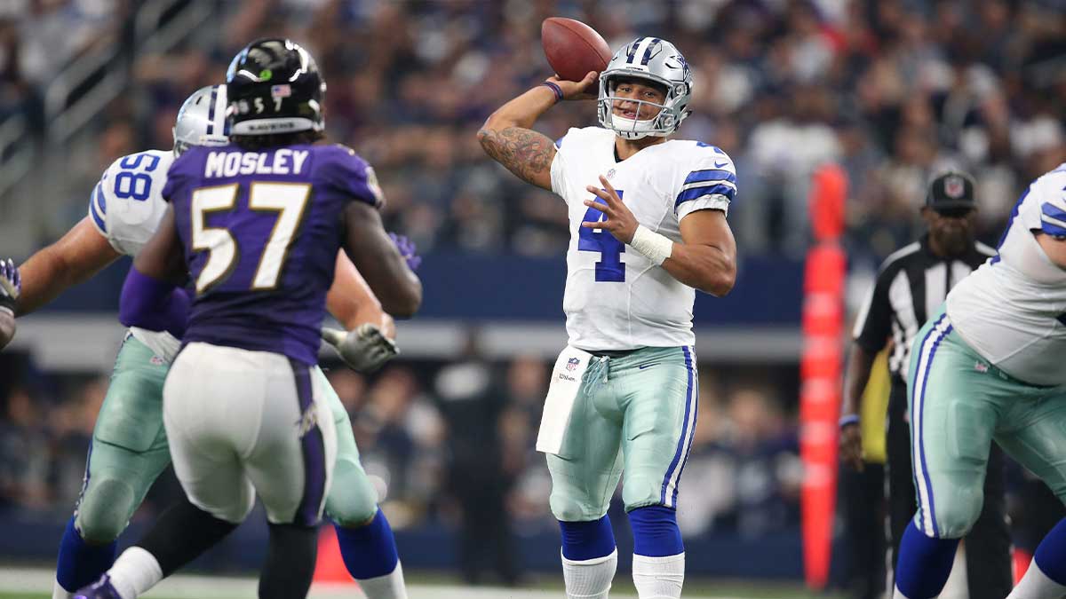 Dallas Cowboys quarterback Dak Prescott (4) throws in the pocket in the fourth quarter against the Baltimore Ravens at AT&T Stadium. 