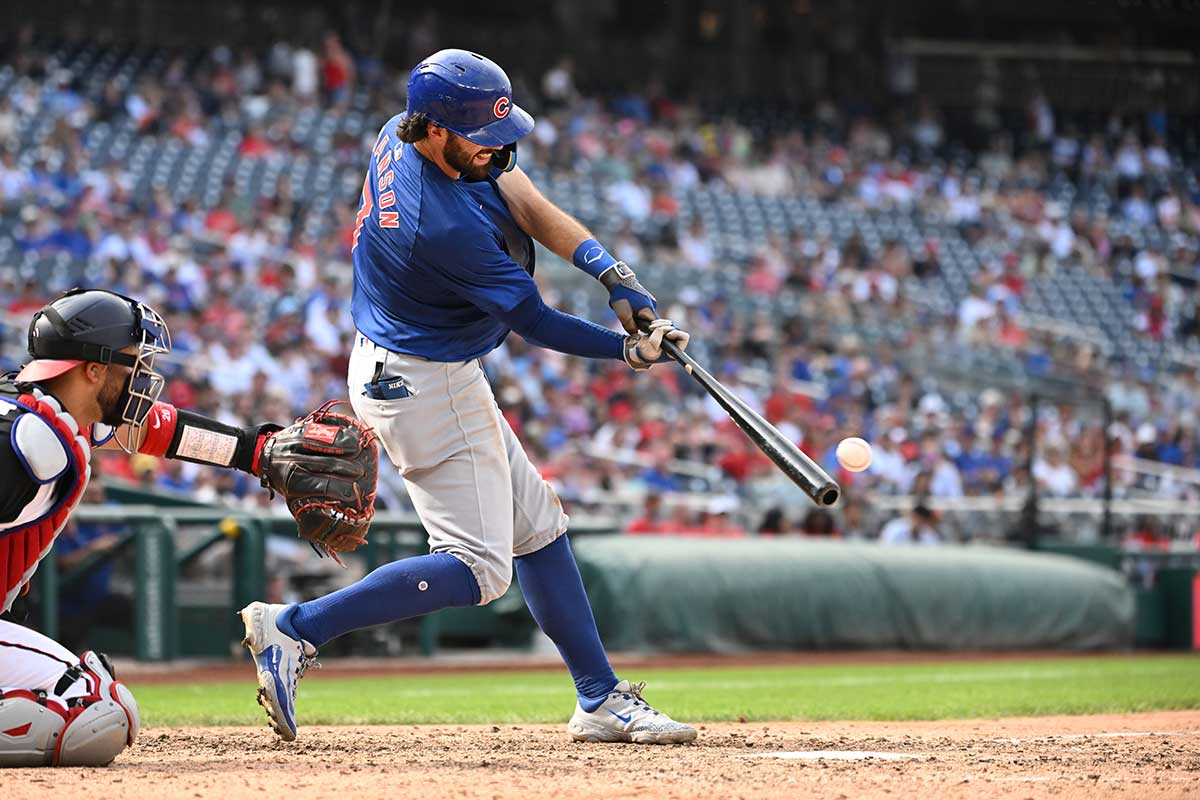 Chicago Cubs shortstop Dansby Swanson (7) hits the ball into play against the Washington Nationals during the ninth inning at Nationals Park.