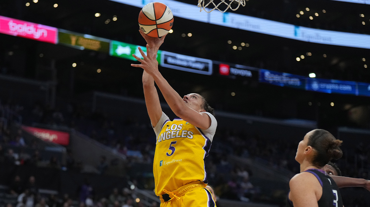 LA Sparks forward Dearica Hamby (5) shoots the ball against Phoenix Mercury forward Natasha Mack (4) and guard Diana Taurasi (3)in the second half at Crypto.com Arena.