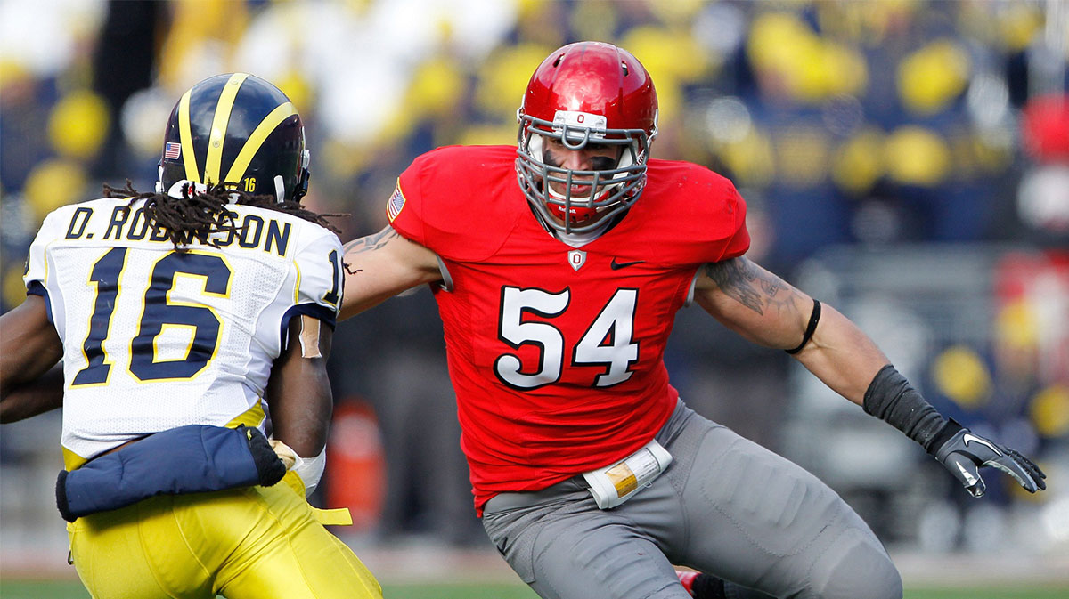Ohio State Buckeyes defensive lineman John Simon (54) goes after Michigan Wolverines quarterback Denard Robinson (16) in the second half of their NCAA football game at the Ohio Stadium
