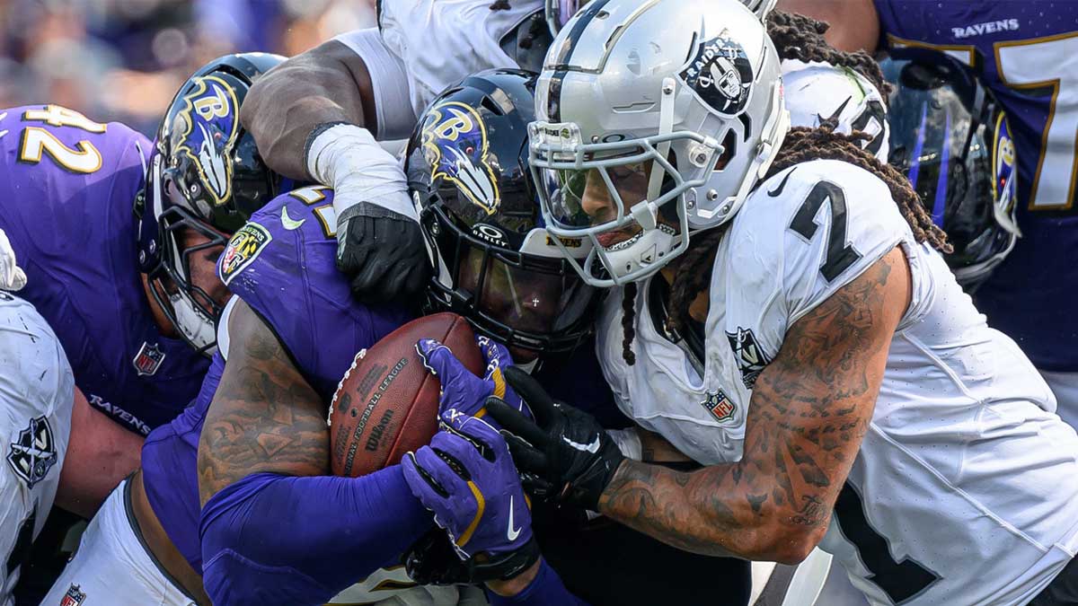 Baltimore Ravens running back Derrick Henry (22) runs for a touchdown while being tackled by Las Vegas Raiders safety Tre'von Moehrig (7) during the second half at M&T Bank Stadium.