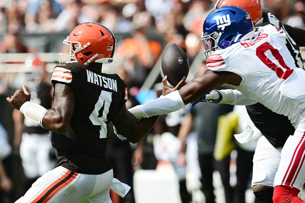 New York Giants linebacker Brian Burns (0) strip sacks Cleveland Browns quarterback Deshaun Watson (4) during the first half at Huntington Bank Field.