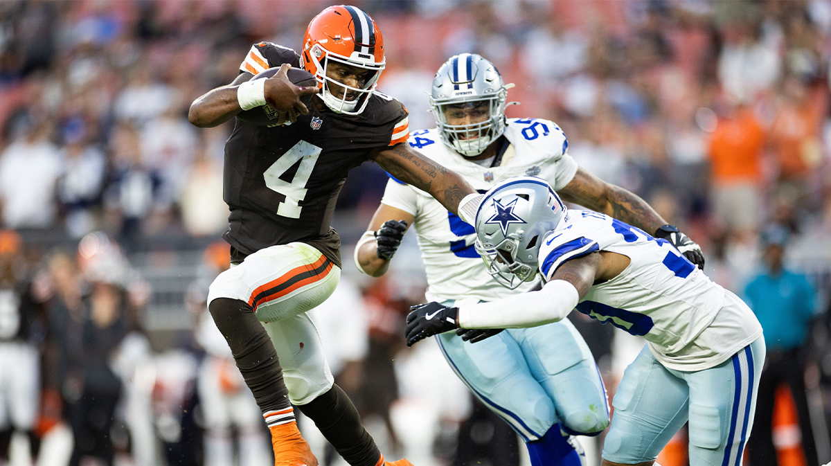 Cleveland Browns quarterback Deshaun Watson (4) pushes Dallas Cowboys safety Juanyeh Thomas (30) away as he runs the ball during the fourth quarter at Huntington Bank Field.