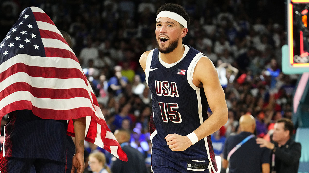 American guard and Phoenix Suns star Devin Booker (15) celebrates after defeating France in the men's basketball gold medal match during the Paris 2024 Summer Olympic Games at Accor Arena.