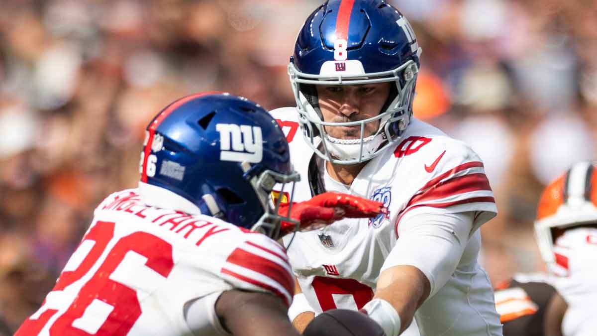 New York Giants quarterback Daniel Jones (8) hands the ball off to running back Devin Singletary (26) during the fourth quarter against the Cleveland Browns at Huntington Bank Field.