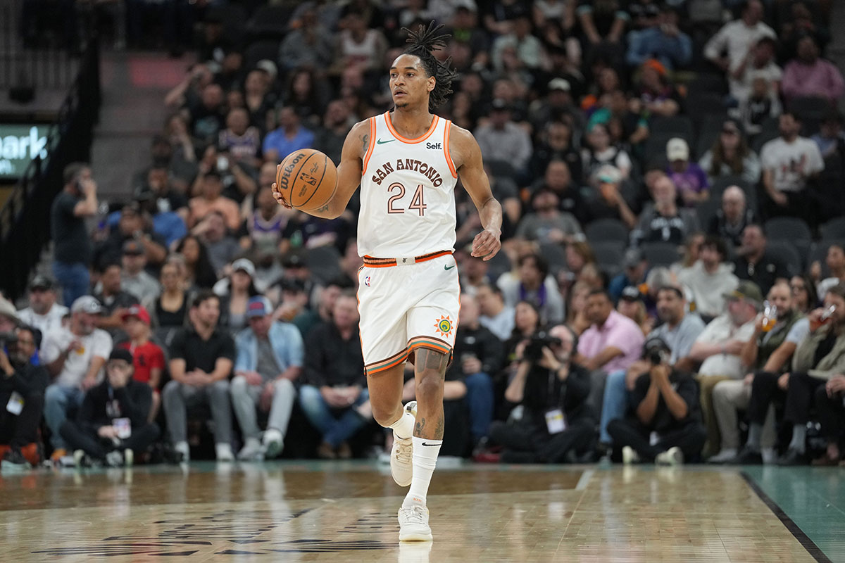 San Antonio Spurs guard Devin Vassell (24) dribbles in the first half against the Phoenix Suns at Frost Bank Center.