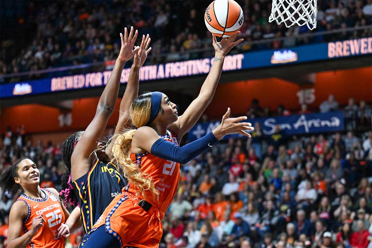 Connecticut Sun guard DiJonai Carrington (21) jumps to shoot the ball past Indiana Fever forward Aliyah Boston (7) in the fourth quarter during game one of the first round of the 2024 WNBA Playoffs at Mohegan Sun Arena.