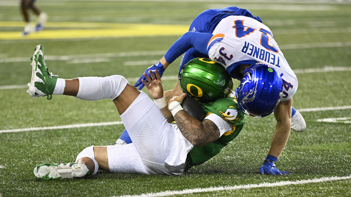 Oregon Ducks quarterback Dillon Gabriel (8) is hit by Boise State Broncos safety Alexander Teubner (34) during the second half at Autzen Stadium. Teubner was ejected from the game for targeting.
