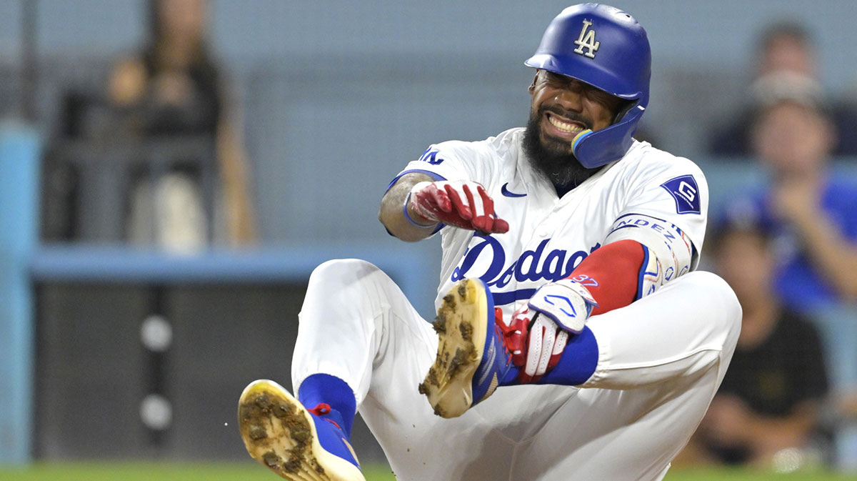 Los Angeles Dodgers left fielder Teoscar Hernandez (37) reacts as he grabs his left foot as he reacts after being hit by a pitch in the first inning against the Cleveland Guardians at Dodger Stadium.