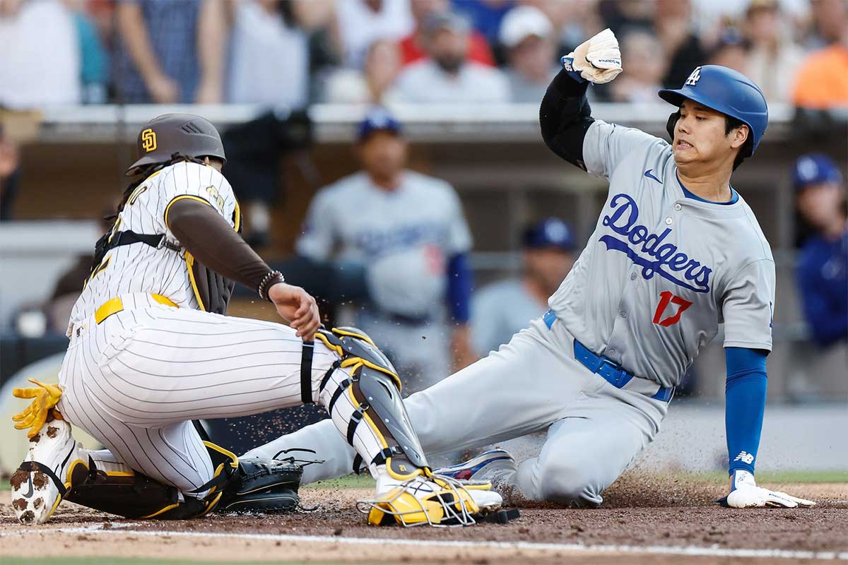 San Diego Padres catcher Luis Campusano (12) tags Los Angeles Dodgers designated hitter Shohei Ohtani (17) out at the plate to end the third inning against the Los Angeles Dodgers at Petco Park