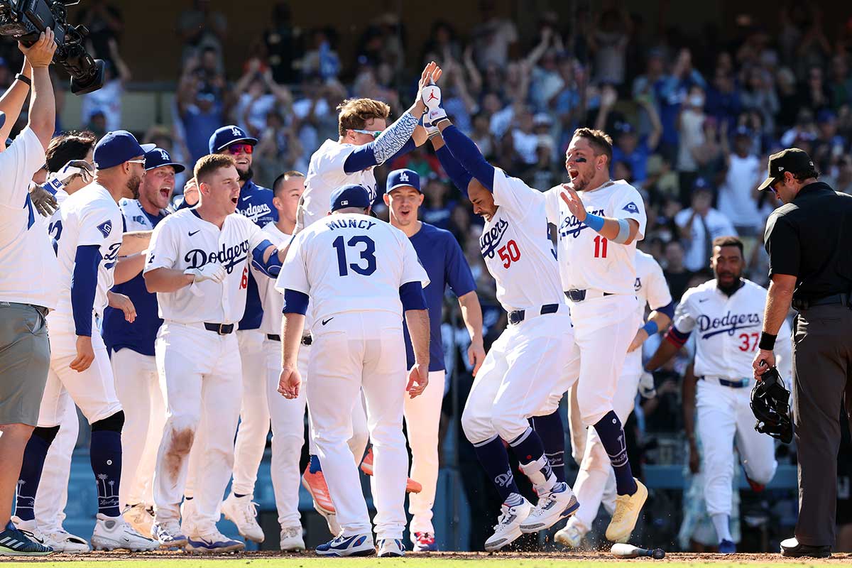 Dodgers right fielder Mookie Betts (50) celebrates with teammates after hitting a game winning home run in bottom of the ninth inning against the Colorado Rockies at Dodger Stadium