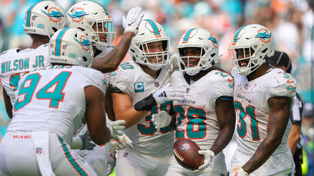 Miami Dolphins running back De'Von Achane (28) celebrates his touchdown with Miami Dolphins running back Raheem Mostert (31) against the Denver Broncos in the fourth quarter at Hard Rock Stadium. 