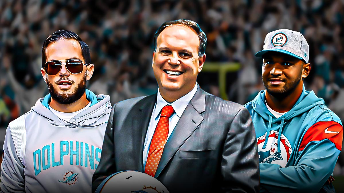 Former Miami Dolphins executive Mike Tannenbaum in the center with Tua Tagovailoa and Mike McDaniel on either side in front of Hard Rock Stadium.