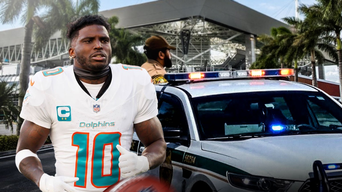 Miami Dolphins Tyreek Hill with Miami-Dade police around him as Hill wants change after arrest and detainment by police.