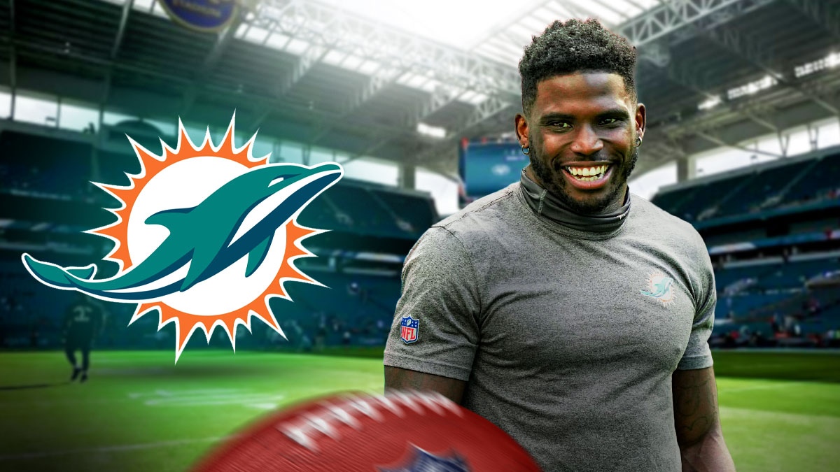 Miami Dolphins logo on left side, Miami Dolphins wide receiver Tyreek Hill celebrating on the right side, Hard Rock Stadium (home stadium of the Miami Dolphins) in background