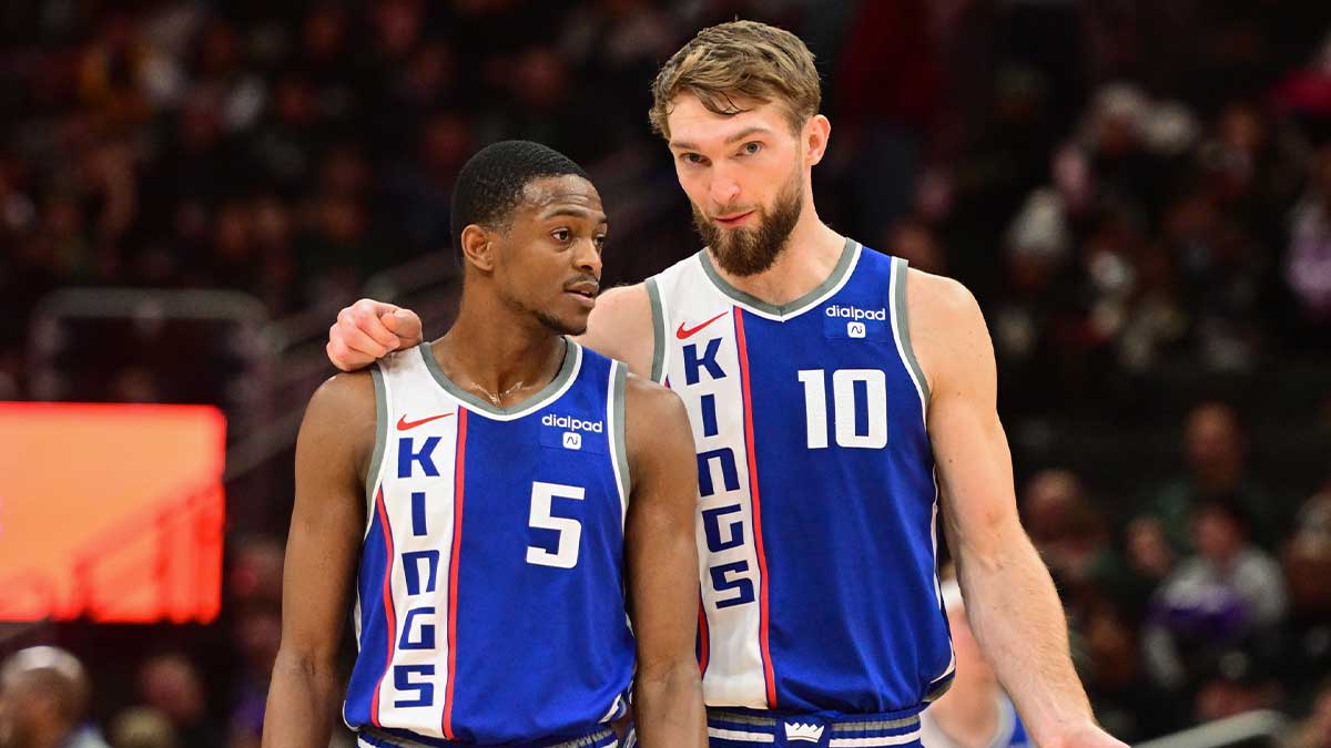 Sacramento Kings guard De'Aaron Fox (5) and center Domantas Sabonis (10) talk during a timeout in the third quarter against the Milwaukee Bucks at Fiserv Forum.