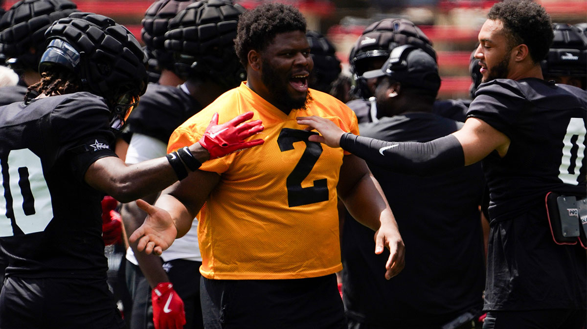 Cincinnati Bearcats defensive tackle Dontay Corleone (2) embraces his teammates during a scrimmage