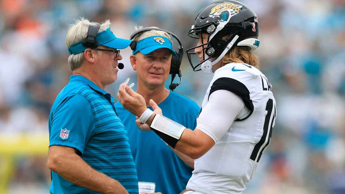 Jacksonville Jaguars quarterback Trevor Lawrence (16) talks with head coach Doug Pederson, left, as quarterbacks coach Mike McCoy looks on during the third quarter of an NFL football matchup Sunday, Sept. 15, 2024 at EverBank Stadium in Jacksonville, Fla. The Browns defeated the Jaguars 18-13.