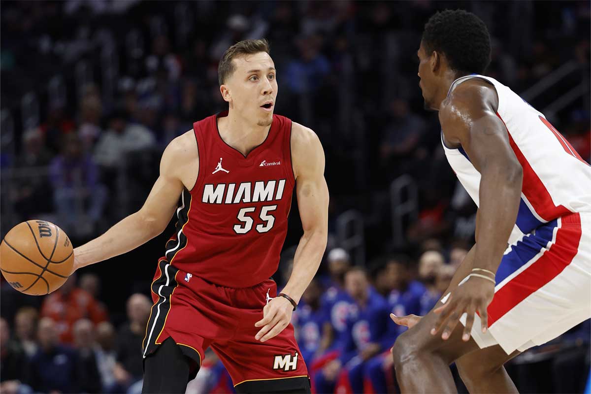 Miami Heat forward Duncan Robinson (55) dribbles defended by Detroit Pistons center Jalen Duren (0) in the first half at Little Caesars Arena.