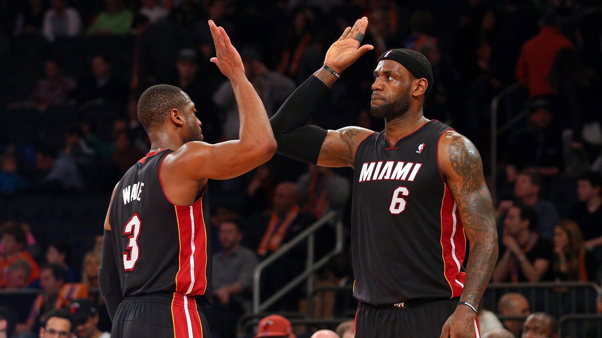 LeBron James (6) high fives Heat shooting guard Dwyane Wade (3)