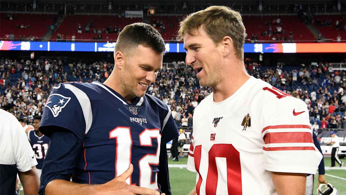 New England Patriots quarterback Tom Brady (12) and New York Giants quarterback Eli Manning (10) shake hands after a preseason game at Gillette Stadium.