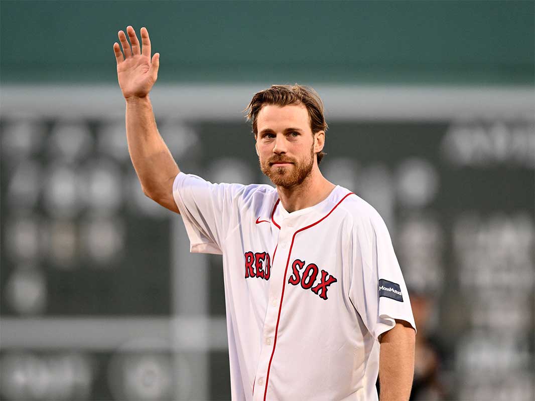 Boston Bruins center Elias Lindholm (28) waves to the crowd before throwing a ceremonial first pitch before a game between the Boston Red Sox and the Chicago White Sox at Fenway Park.