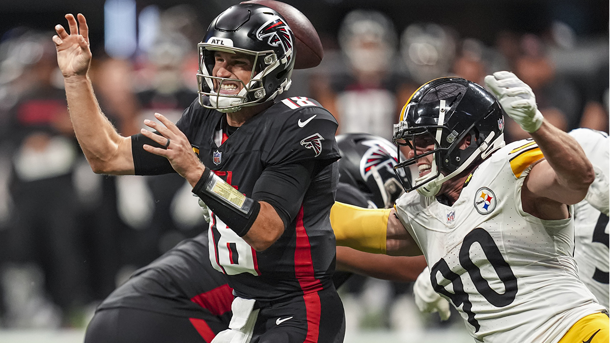 Pittsburgh Steelers linebacker T.J. Watt (90) strips the ball from Atlanta Falcons quarterback Kirk Cousins (18) at Mercedes-Benz Stadium.