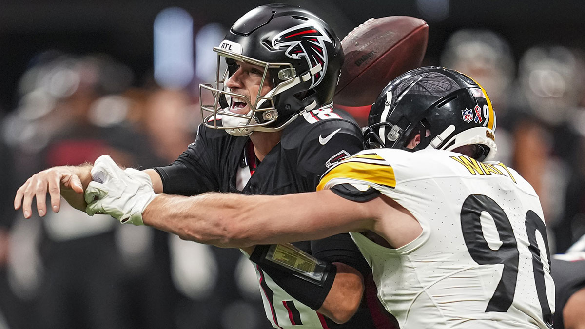 Pittsburgh Steelers linebacker T.J. Watt (90) strips the ball from Atlanta Falcons quarterback Kirk Cousins (18) at Mercedes-Benz Stadium.