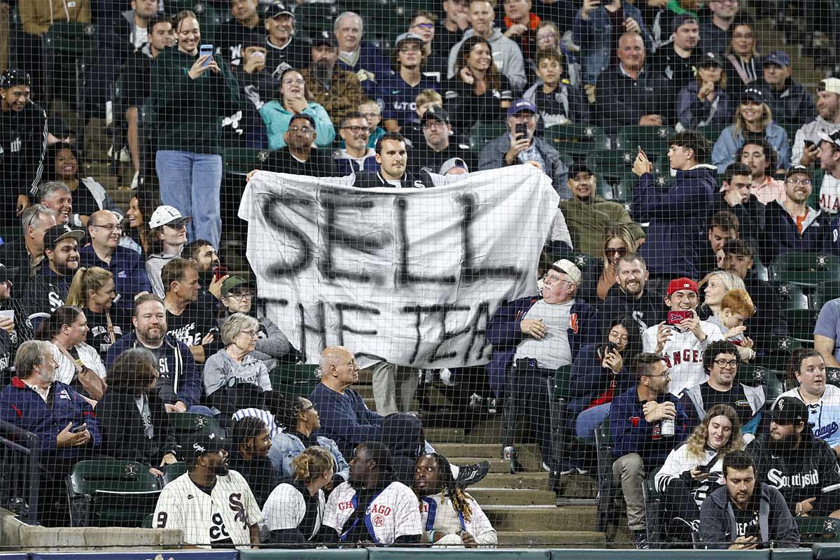 A spectator holds Sell The Team banner during the eight inning of a baseball game between the Chicago White Sox and Los Angeles Angels at Guaranteed Rate Field.