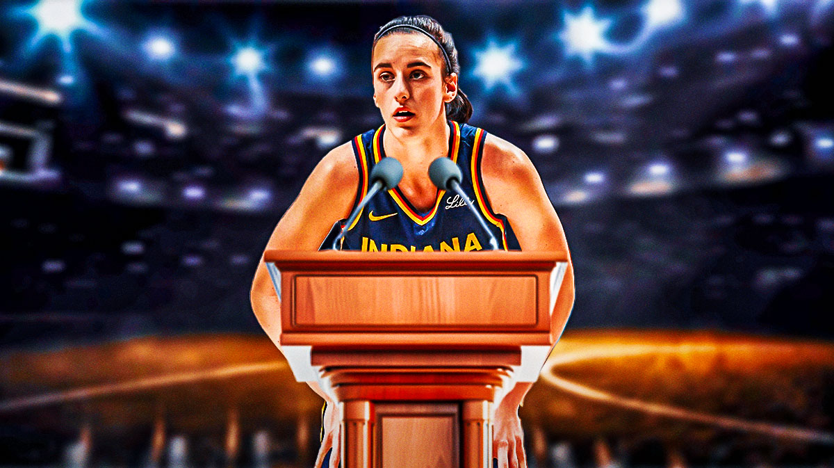 Fever guard Caitlin Clark standing in front of a microphone at a podium next to the WNBA logo