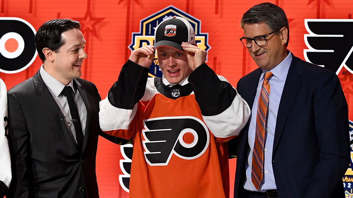 Philadelphia Flyers draft pick Matvei Michkov puts on his hat after being selected seventh overall in the first round of the 2023 NHL Draft at Bridgestone Arena.