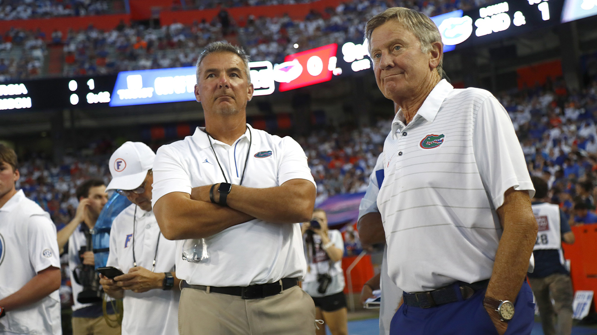 Florida Gators former head coach Urban Meyer and Steve Spurrier on the sidelines during the first quarter against the Florida Atlantic Owls at Ben Hill Griffin Stadium.