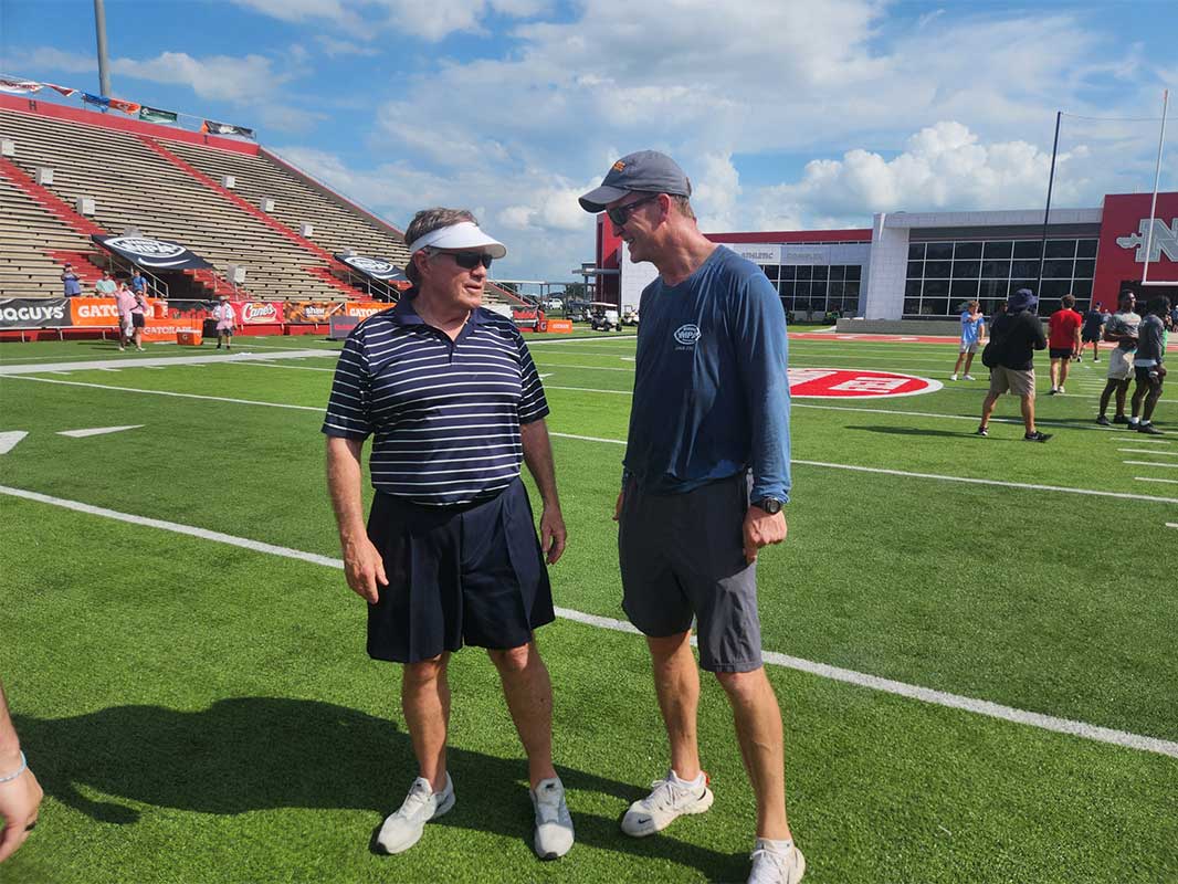 Legendary former NFL coach Bill Belichick talks with Peyton Manning at the 2024 Manning Passing Academy.