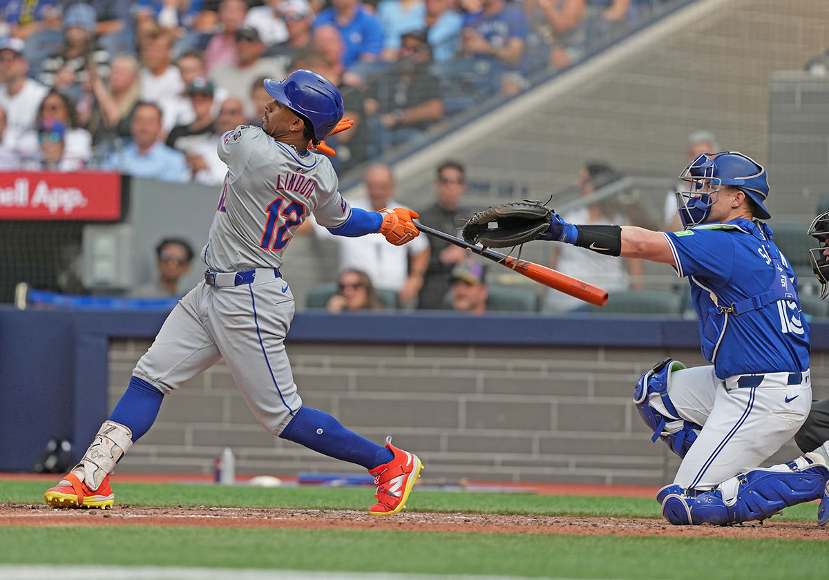 Sep 11, 2024; Toronto, Ontario, CAN; New York Mets shortstop Francisco Lindor (12) hits a home run against the Toronto Blue Jays during the ninth inning at Rogers Centre.