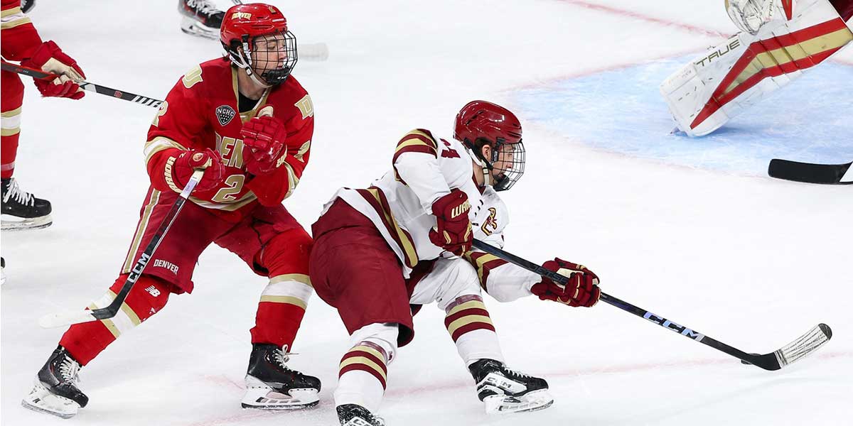 Boston College Eagles forward Gabe Perreault (34) skates with the puck as Denver Pioneers defenseman Sean Behrens (2) defends during the first period of the championship game of the 2024 Frozen Four college ice hockey tournament at Xcel Energy Center.