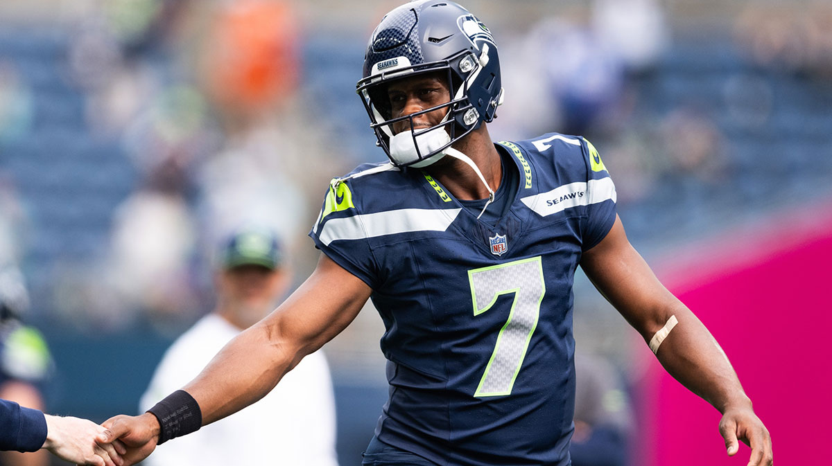 Seattle Seahawks quarterback Geno Smith (7) high fives a team member before the game against Miami Dolphins at Lumen Field.