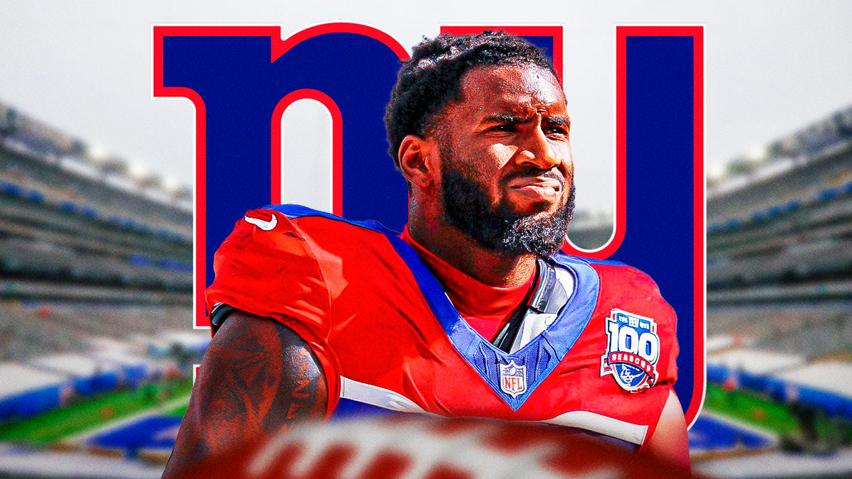 Brian Burns looking upset in front of a Giants logo