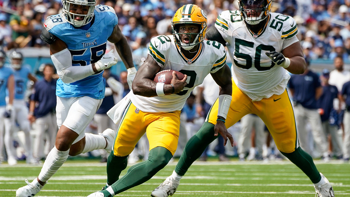 Green Bay Packers quarterback Malik Willis (2) runs the ball past Tennessee Titans linebacker Harold Landry III (58) during the second quarter at Nissan Stadium in Nashville, Tenn., Sunday, Sept. 22, 2024.
