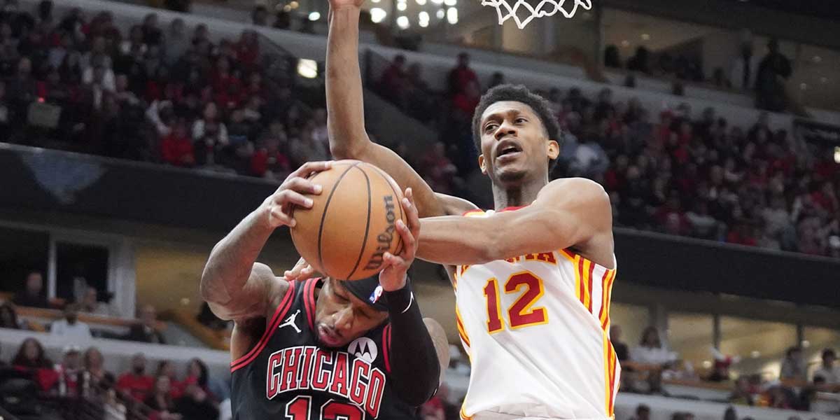 Chicago Bulls forward Torrey Craig (13) defends Atlanta Hawks forward De'Andre Hunter (12) during the second half during a play-in game of the 2024 NBA playoffs at United Center. 